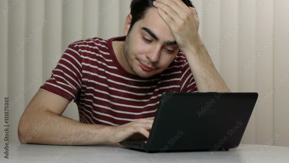 Bored young man in front of his laptop. Bored young man in front of his laptop.
