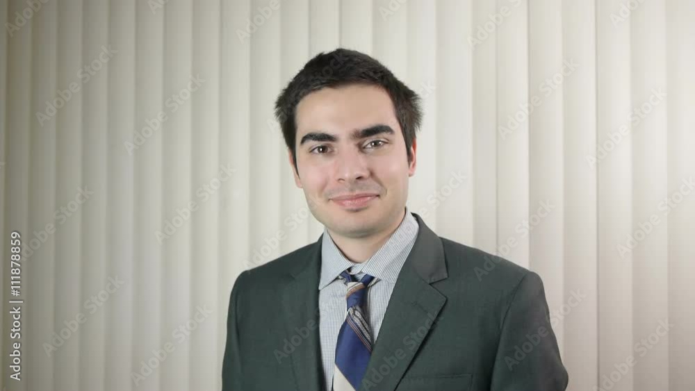 Young businessman looking at the camera and smiling Young businessman looking at the camera and smiling