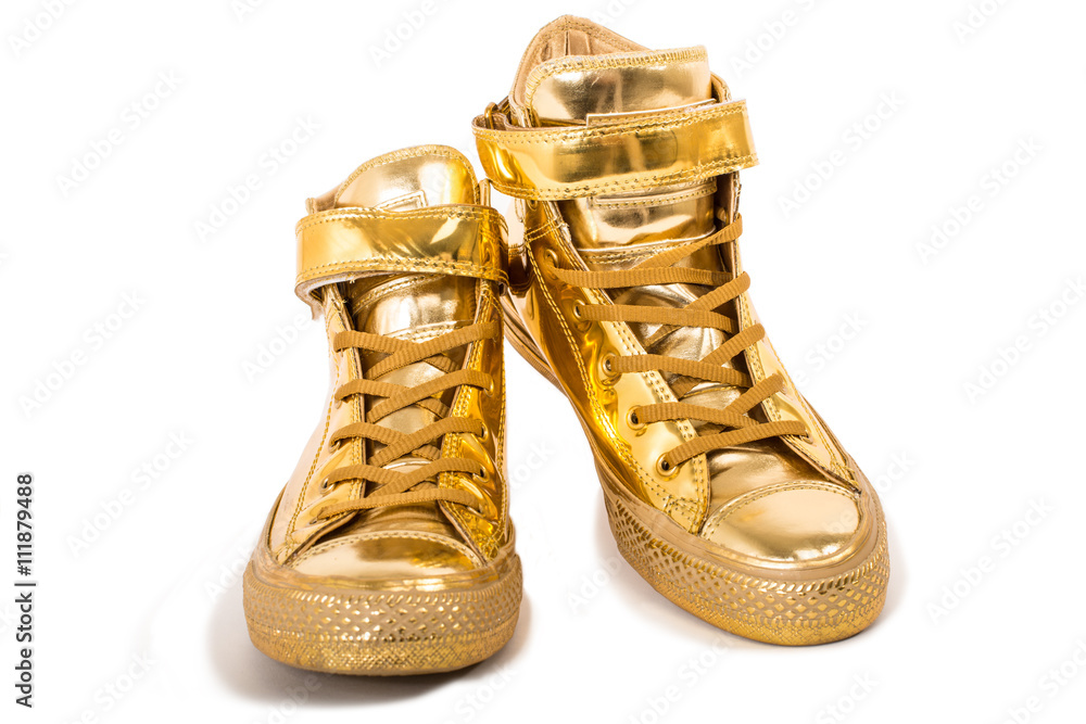 Pair of golden sneakers isolated Stock Photo | Adobe Stock