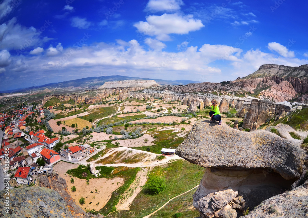 Young woman on a stone  in Goreme, Cappadocia,  Turkey