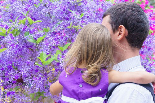 Dad and daughter in the background of purple wood © yarochkins