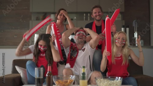 4k footage, austrian fans watching tv at home supporting austria, disappointed
 photo