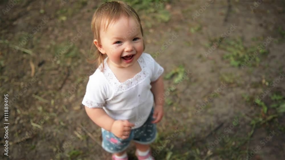 Beautiful child laughs in the park, close-up Beautiful child laughs in the park, close-up