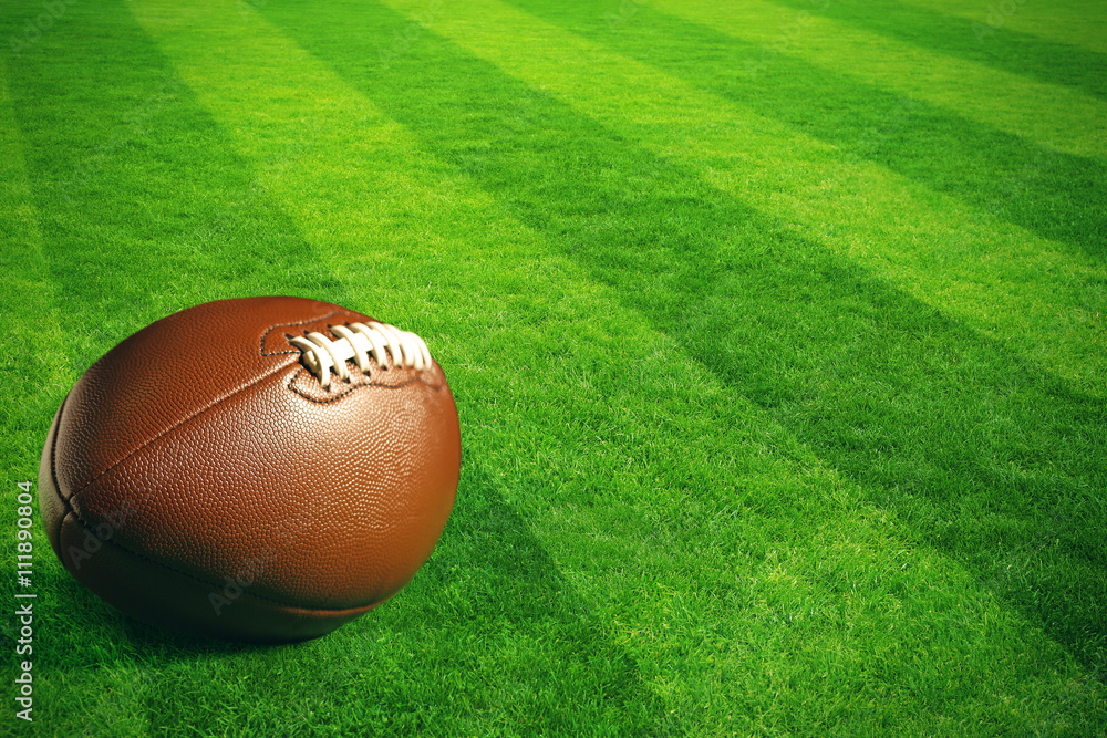 Obraz premium American football on green field stadium background
