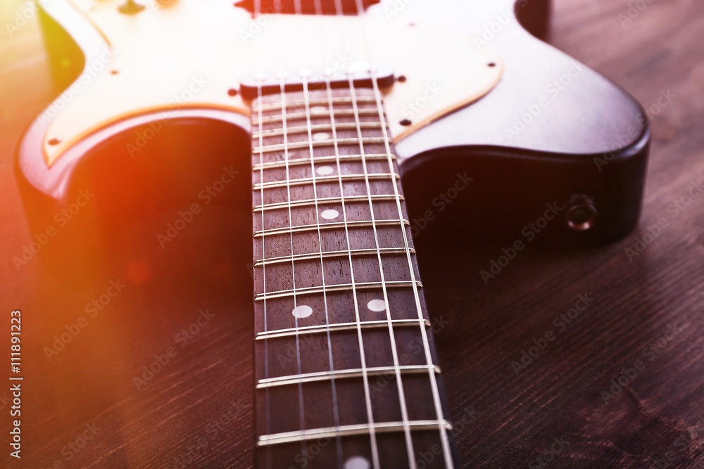 Electric guitar on wooden background with light effect Electric guitar on wooden background with light effect