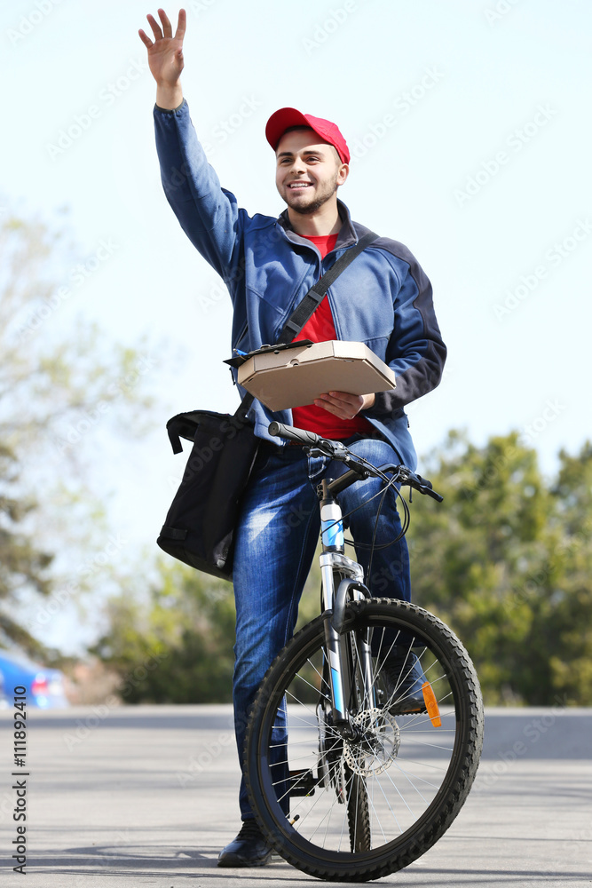 Young man with bike delivering pizza Young man with bike delivering pizza