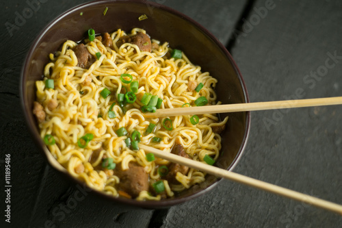 Asian quick noodles on wood with focus and blur background
