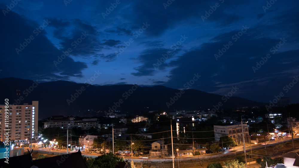 mountain view, cityscape and traffic on road in evening