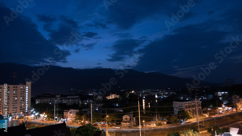 mountain view, cityscape and traffic on road in evening