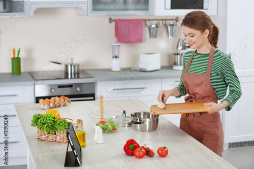 Young woman cooking in the ...