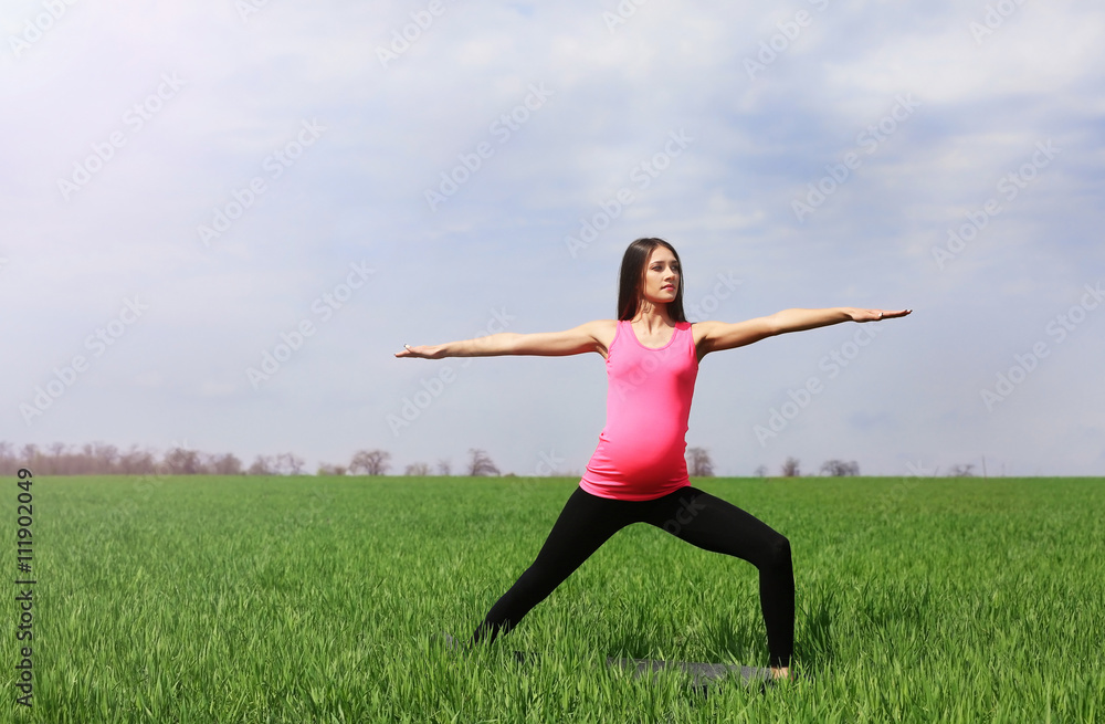 Pregnant woman practicing yoga pose Pregnant woman practicing yoga pose