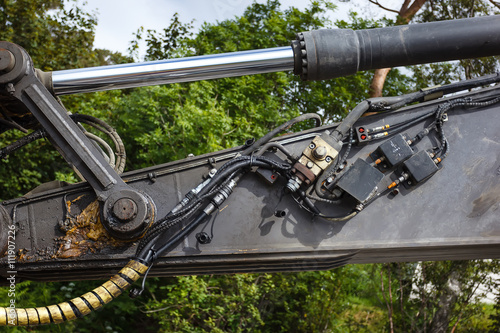 Detail of hydraulic bulldozer excavator piston arm in the mechanical oil and fuel oil on open air
