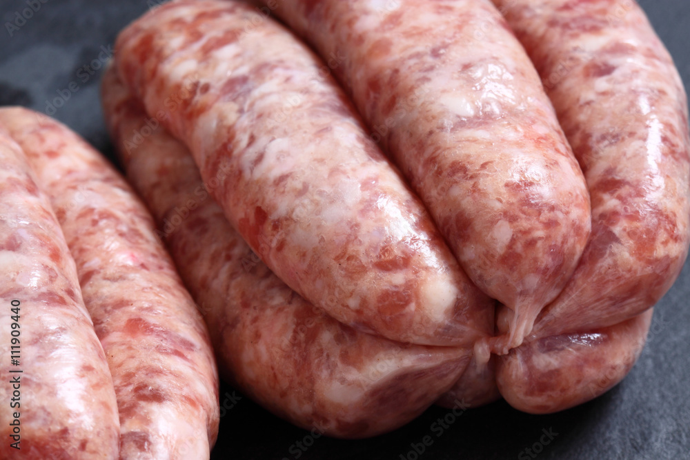 Sausages raw slate / Raw sausages on a slate background Sausages raw slate / Raw sausages on a slate background