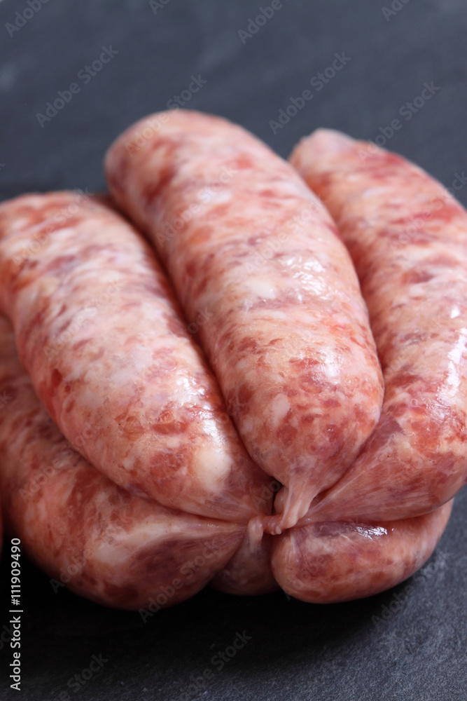 Sausages raw slate / Raw sausages on a slate background Sausages raw slate / Raw sausages on a slate background