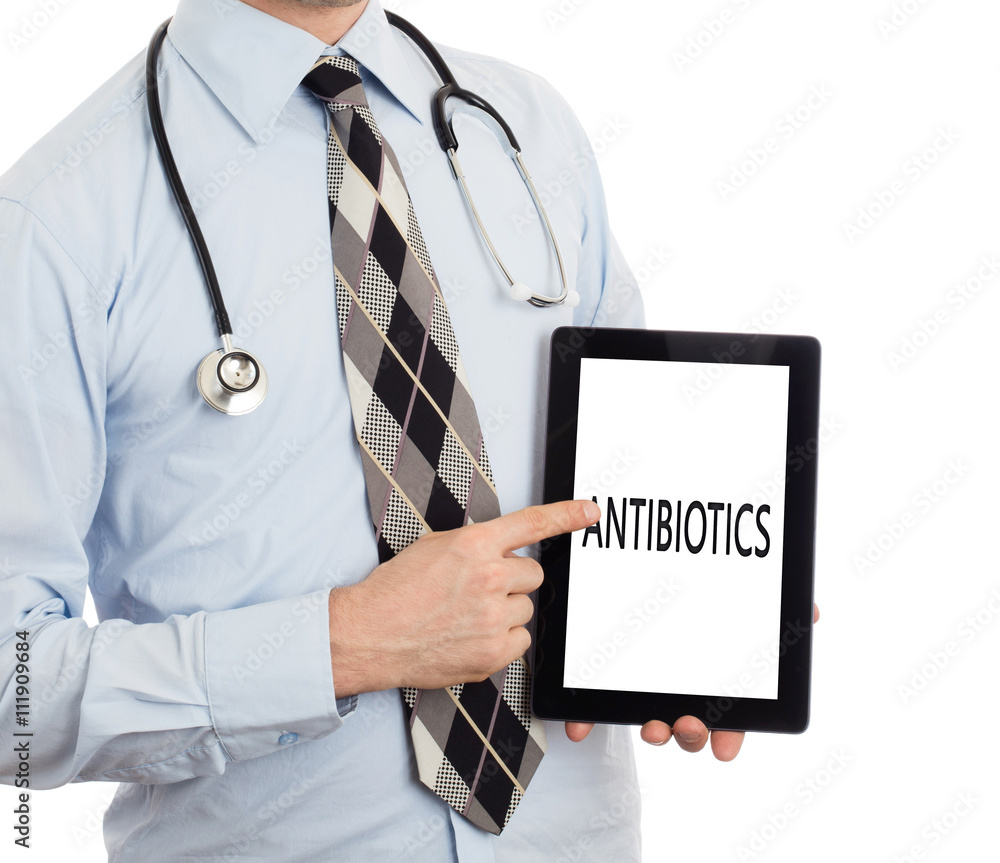Doctor holding tablet - Antibiotics Doctor holding tablet - Antibiotics