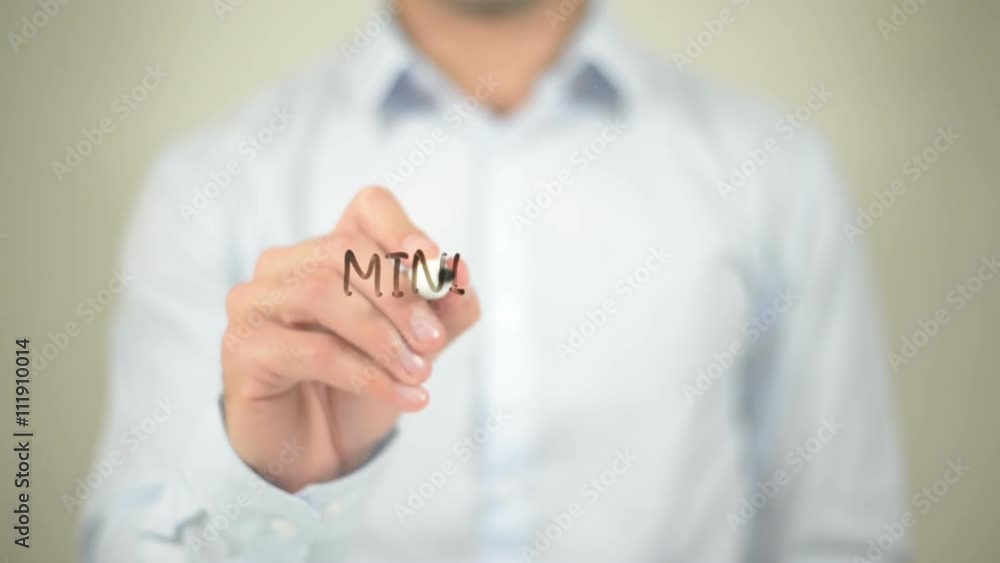 Minimum wage , man writing on transparent wall Minimum wage , man writing on transparent wall
