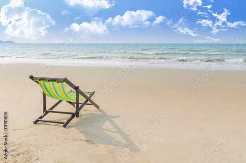 Beach chair on the sand with summer, Summer background. Summer fresh concept. Lonely in summer beach. Selective focus on chair. © fongleon356