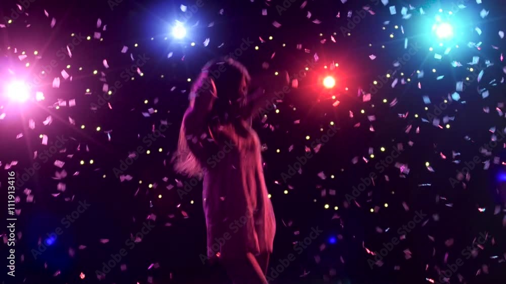 Silhouette of dancing girl with disco style lights and confetti Silhouette of dancing girl with disco style lights and confetti