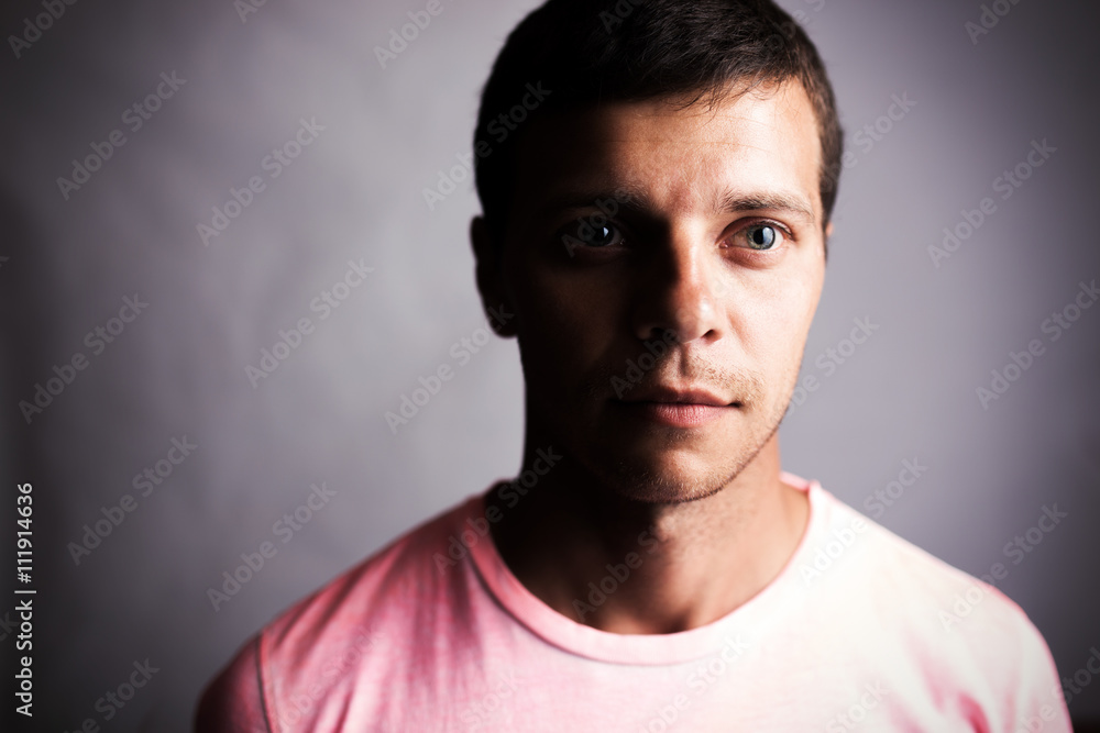 Dark portrait of a young man looking forward