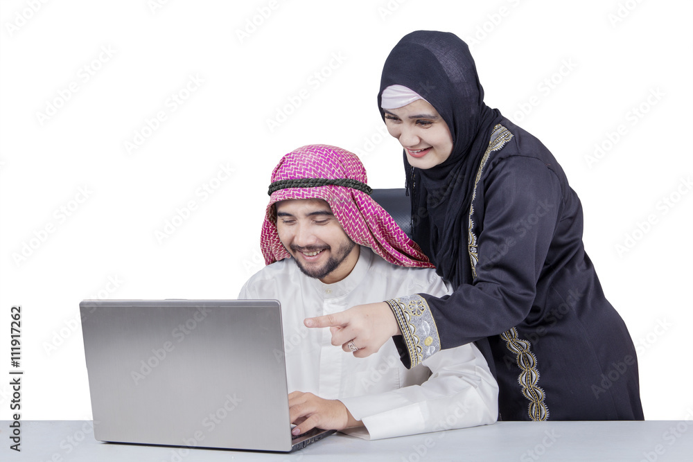 Arabic businesspeople using laptop