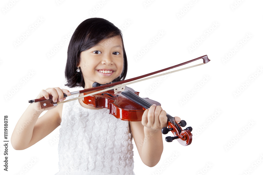Cheerful girl playing violin in the studio Cheerful girl playing violin in the studio