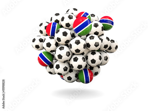 Pile of footballs with flag of gambia