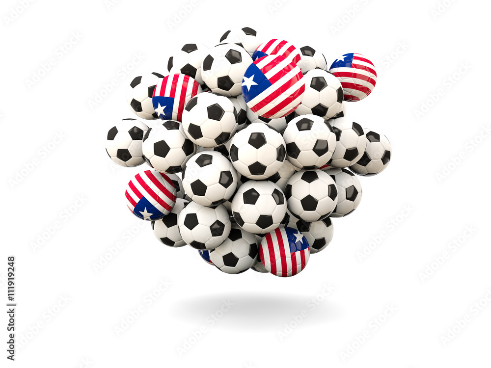Obraz premium Pile of footballs with flag of liberia
