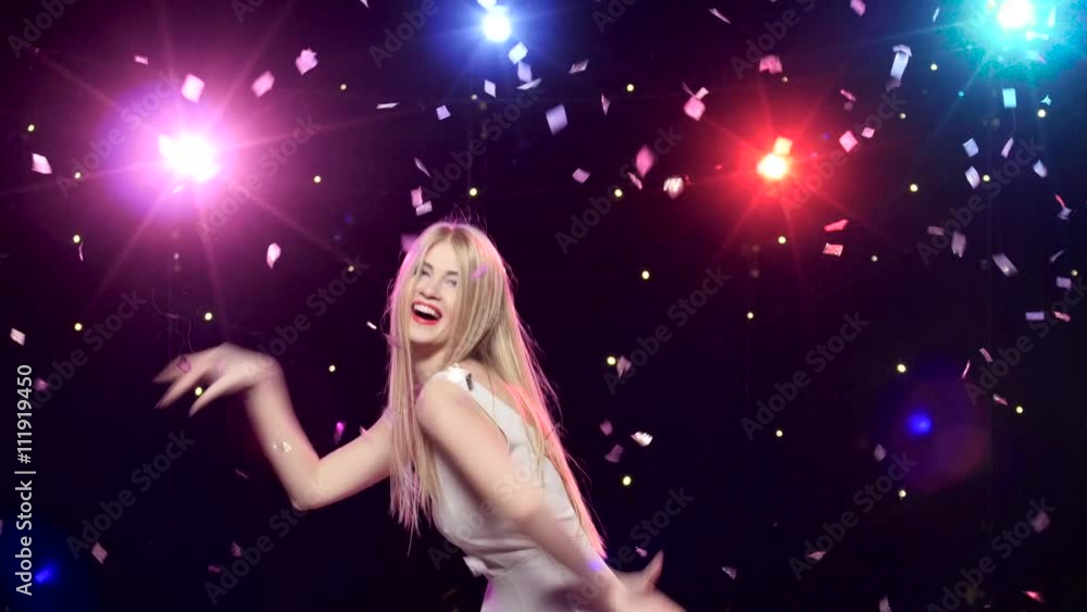 Happy girl are funny dancing against disco lights glitter confetti Happy girl are funny dancing against disco lights glitter confetti