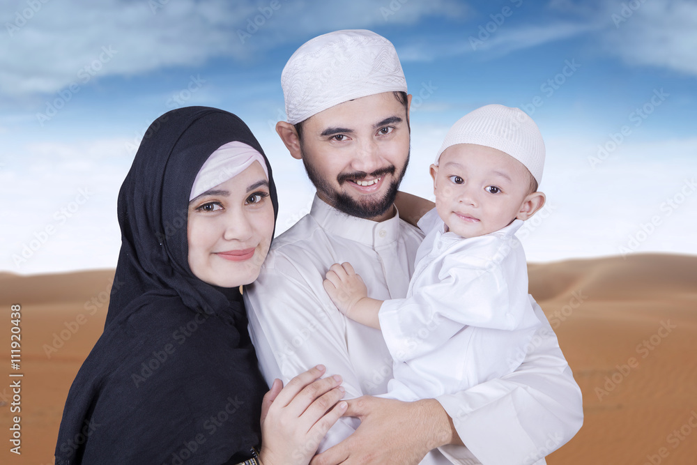 Muslim man with his wife and son at desert Muslim man with his wife and son at desert