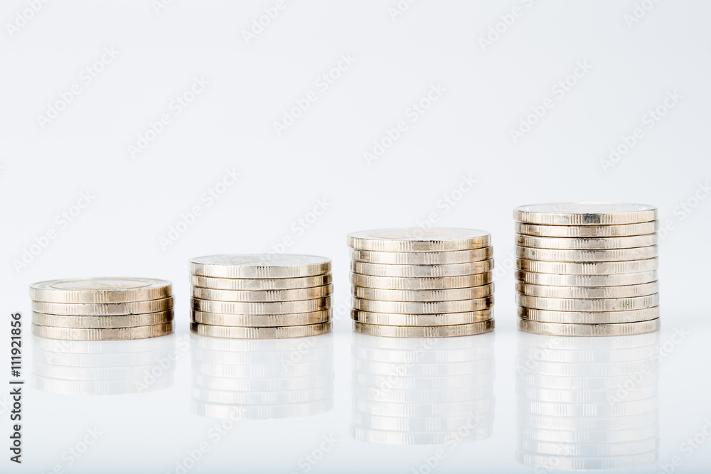 Savings, increasing columns of coins on white background Savings, increasing columns of coins on white background