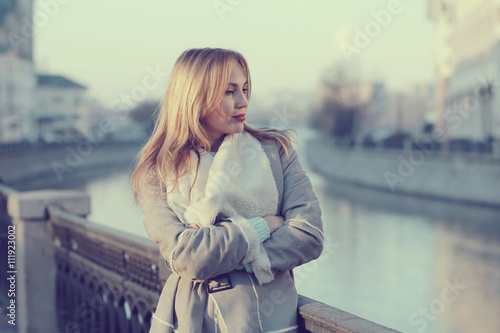 Spring warm blonde portrait in the city