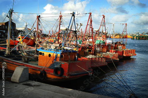 Typical orange fishing boats on the port of the coastal city of  Mar del Plata, Argentina. photo