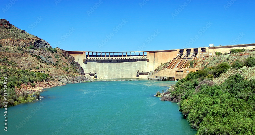 Dam in Karoo (semi desert) in South Africa on a background of beautiful blue sky and turquoise water.
