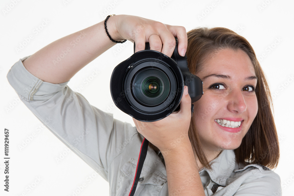Smiling Female Photographer Shooting You isolated on white Smiling Female Photographer Shooting You isolated on white
