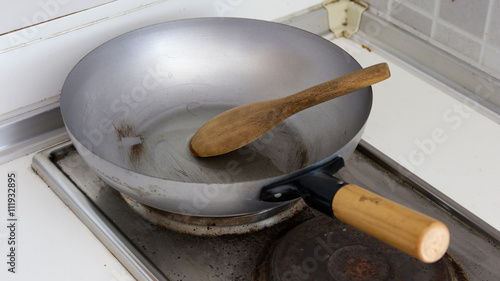Wood ladle on steel pan ready to cook