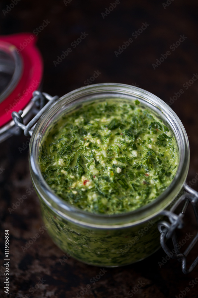 Homemade parsley and basil pesto in a jar Homemade parsley and basil pesto in a jar