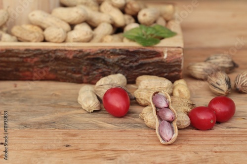 Peanut and boiled peanuts on wood background.