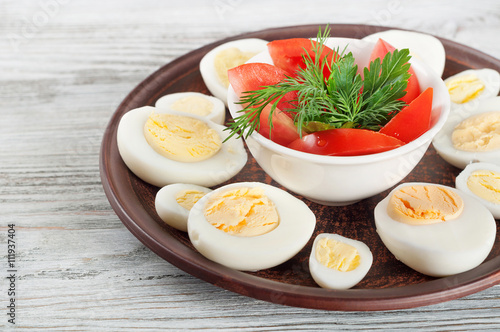 Boiled hen eggs and red tomato