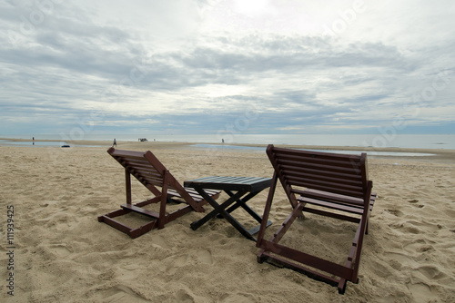 Cloudy sky on the beach with table and chair