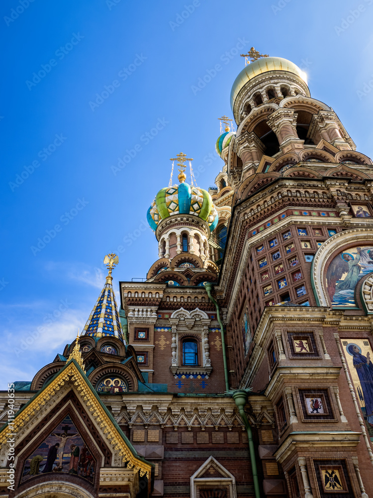 Detail of the richly decorated facade and onion domes of the Church of the Savior on Blood. Saint-Petersburg, Russia