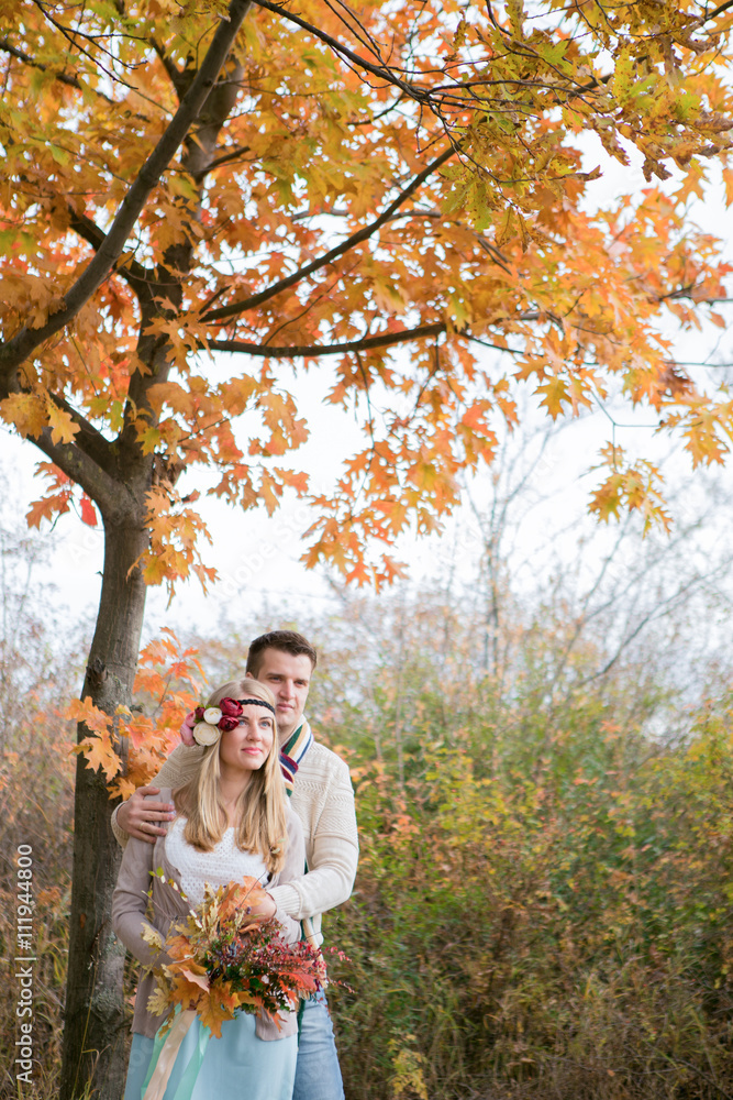 Autumn wedding in boho style. Autumn leaf fall, autumnal forest. loving couple, man and woman. orange pumpkin - obrazy, fototapety, plakaty 