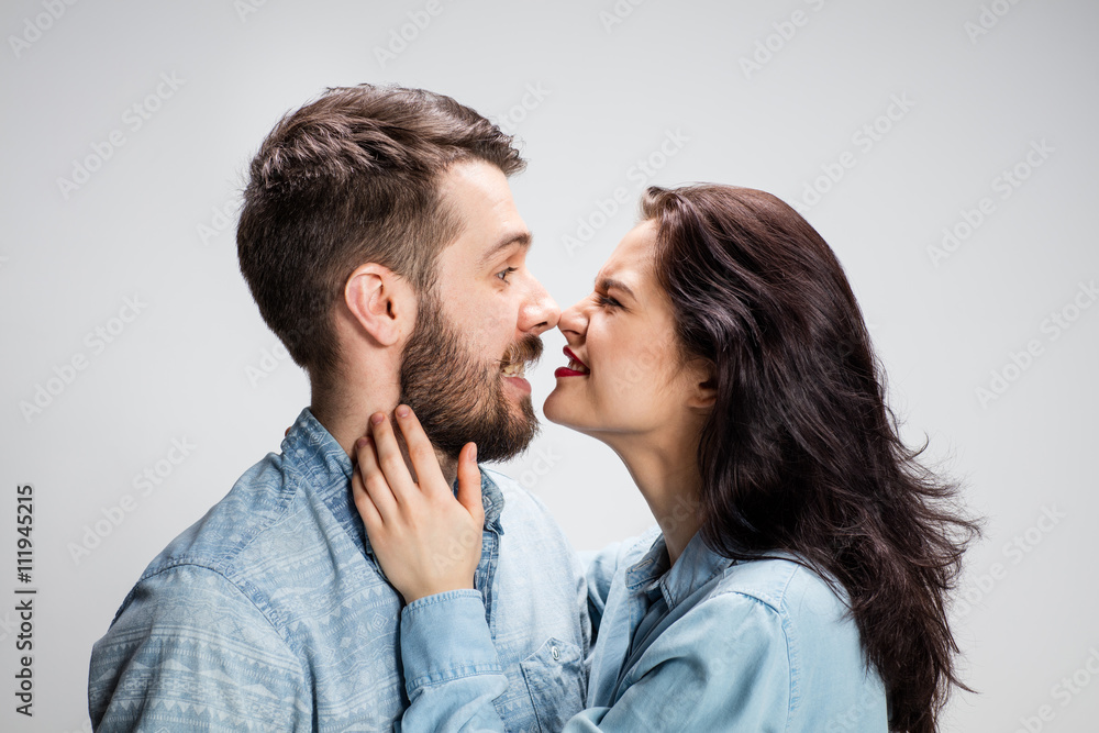 Portrait of happy couple on gray background Portrait of happy couple on gray background