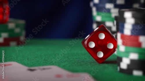 Red dice in sequence rolls, casino chips, cards on green felt