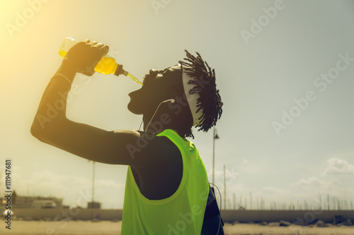 Sportive man drinking outdoor  photo