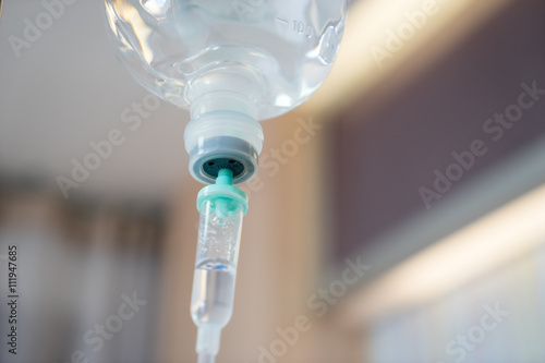 Infusion bottle with IV solution in hospital photo