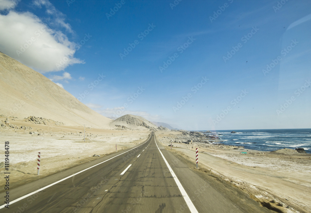 highway in chilean desert through the coast line