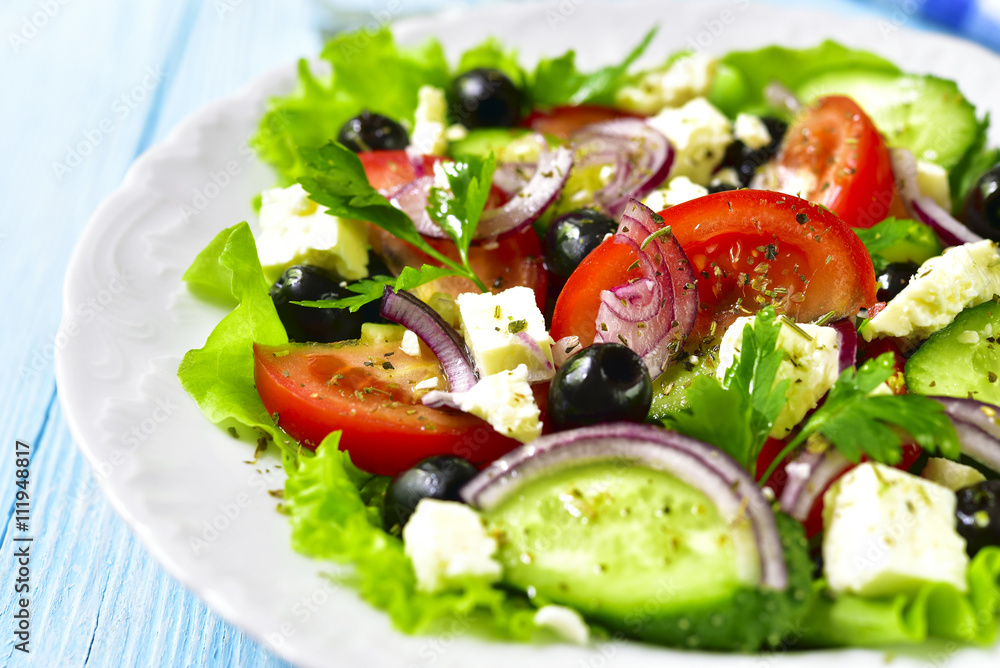 Traditional greek salad on a white plate. Traditional greek salad on a white plate.