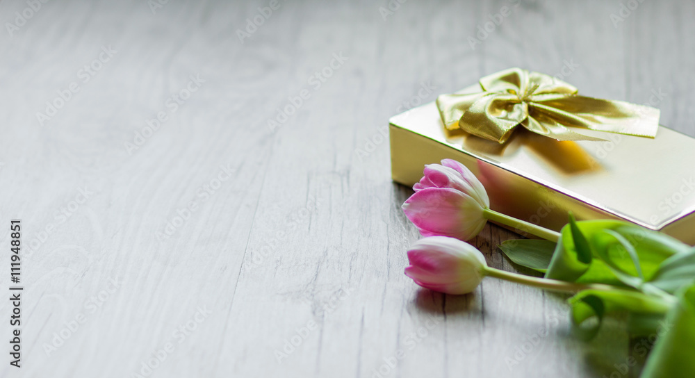 Tulips and gift on a gray background Tulips and gift on a gray background