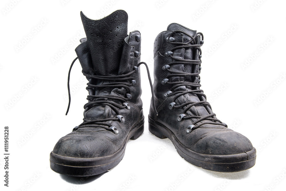 Pair of old military shoes/Old dirty army boots made of black leather on white background Pair of old military shoes/Old dirty army boots made of black leather on white background