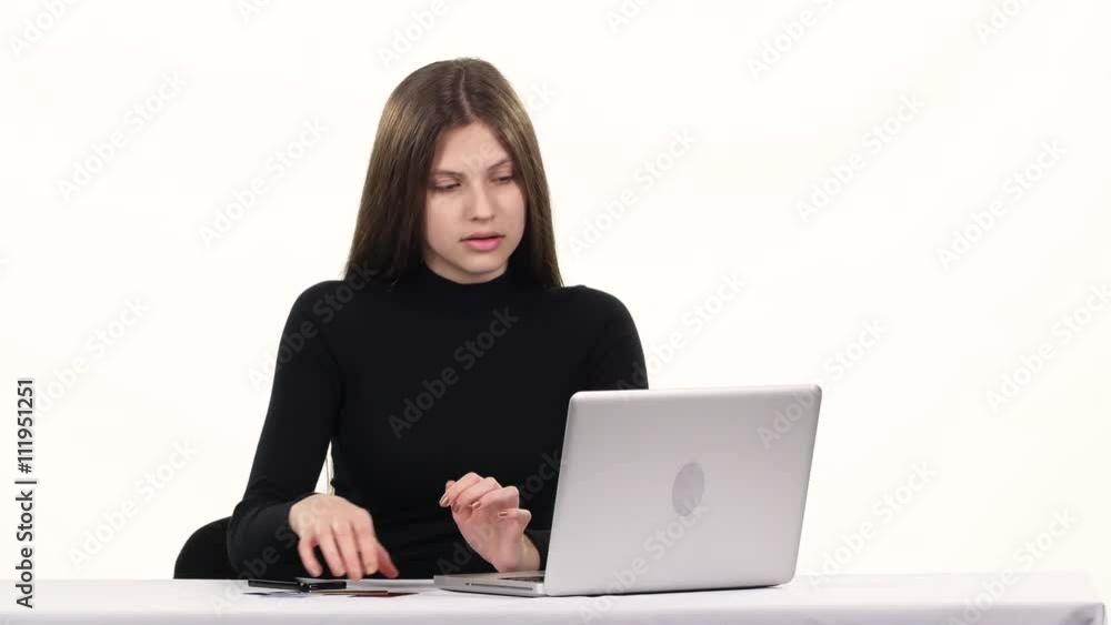 Girl makes a purchase online and pay by card. White Girl makes a purchase online and pay by card. White